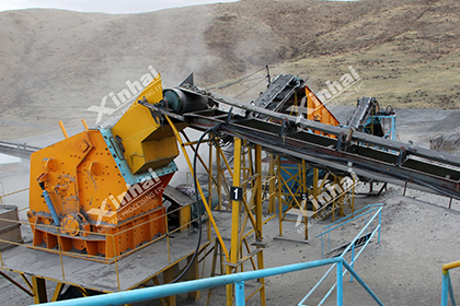 A pic showing a yellow jaw crusher working with s belt conveyor
